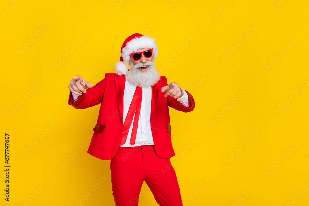 Photo of cheerful aged man have fun dancing point fingers you enjoy x-mas noel event isolated on yellow color background Photo of cheerful aged man have fun dancing point fingers you enjoy x-mas noel event isolated on yellow color background