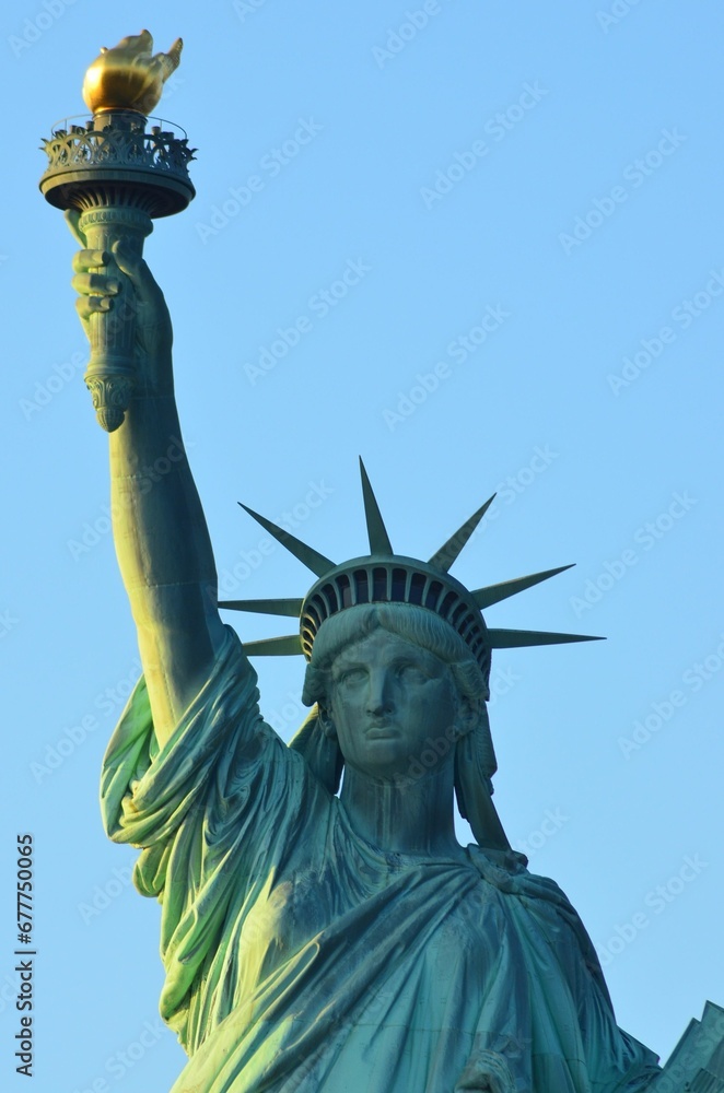 Fototapeta premium Vertical shot of the Statue of Liberty in New York Harbor, NYC