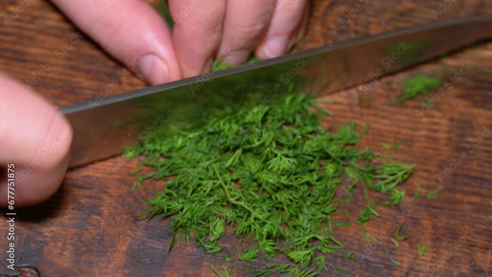 Close-up of cut parsley on a board in the kitchen with a knife. High quality 4k footage Close-up of cut parsley on a board in the kitchen with a knife. High quality 4k footage