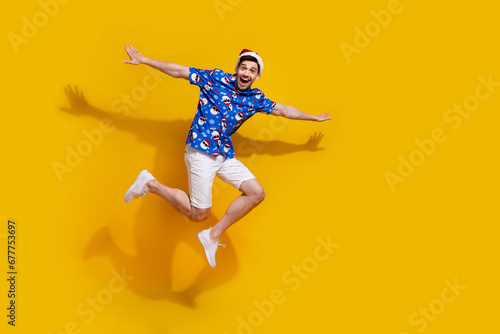 Full body photo of energetic overjoyed man arms wings jump fly empty space isolated on yellow color background © deagreez