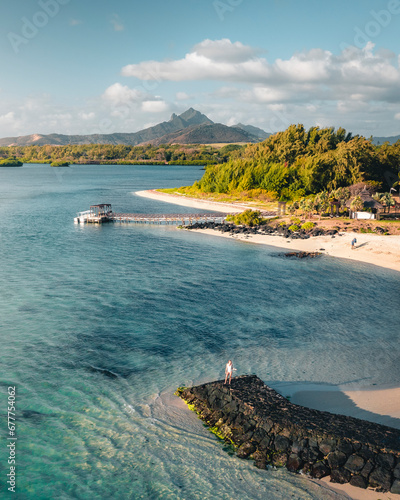 Aerial view of a woman on the breakwater pier at sunset, Ilot Lievres, Trou d'Eau Douce, Flacq district, Mauritius. photo