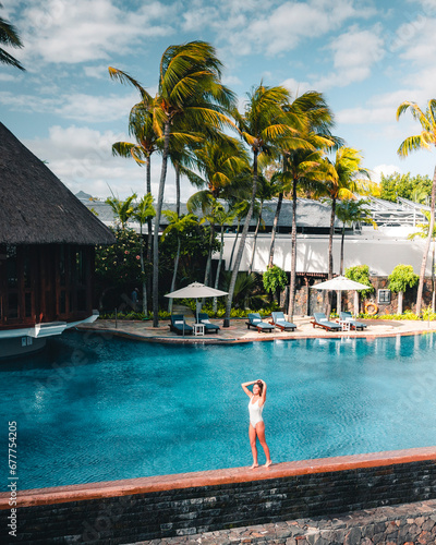 Aerial view of a woman along the swimming pool in luxury resort, Ilot Lievres, Trou d'Eau Douce, Flacq district, Mauritius. photo