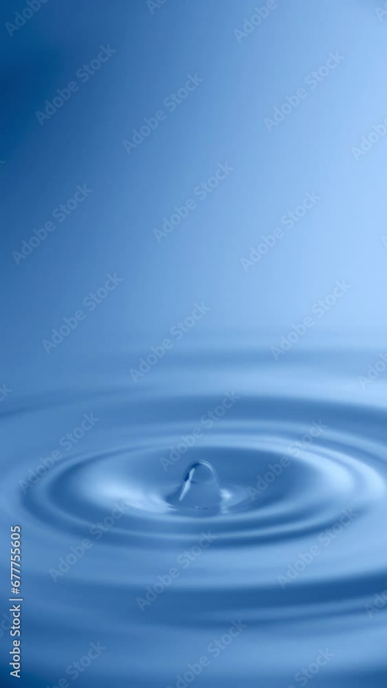 Slow Motion Water drop splash into calm water - shot with ultra high speed camera.- vertical video for your reel Slow Motion Water drop splash into calm water - shot with ultra high speed camera.- vertical video for your reel