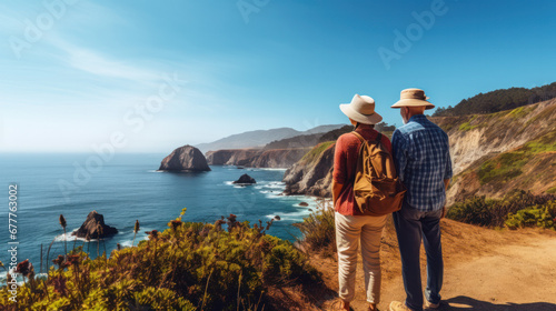 Travel Lifestyle and survival concept rear view. Couple of senior tourists walking along the path up the hill along the seashore on a warm summer day, a back view. Copy space.