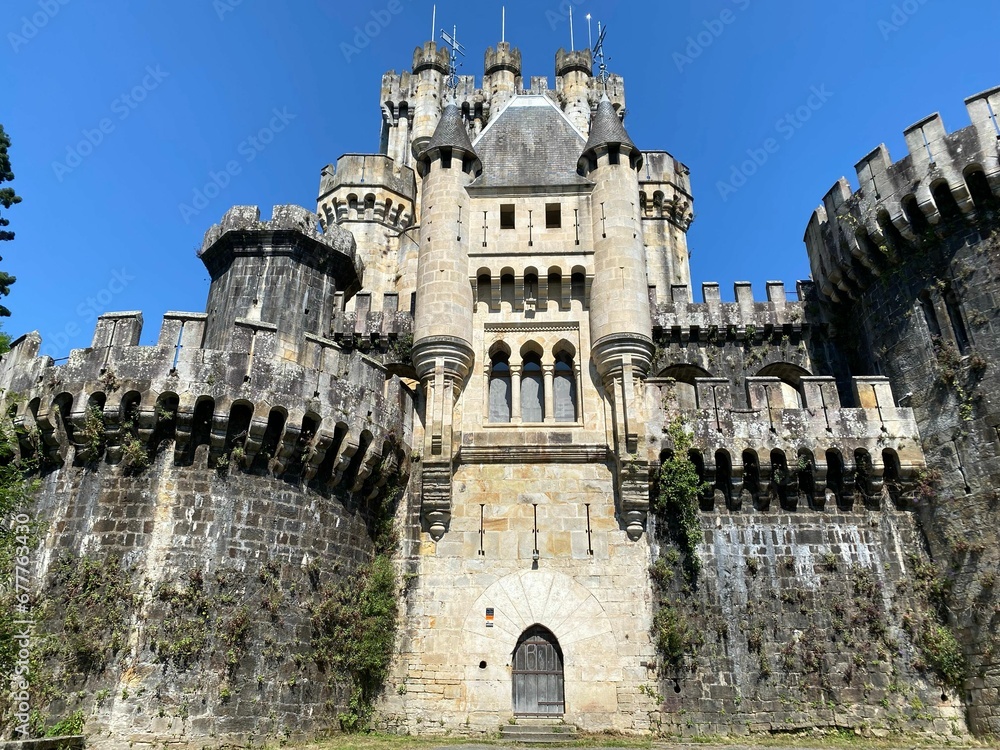 Low angle shot of a castle with a blue sky background