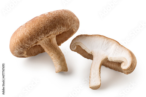 One whole and halved fresh Shiitake mushroom isolated on white background
