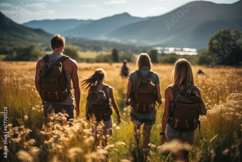 A family and friends hiking together in the mountains in the vacation trip week, sweaty walking in the beautiful nature, fields and hills with grass.