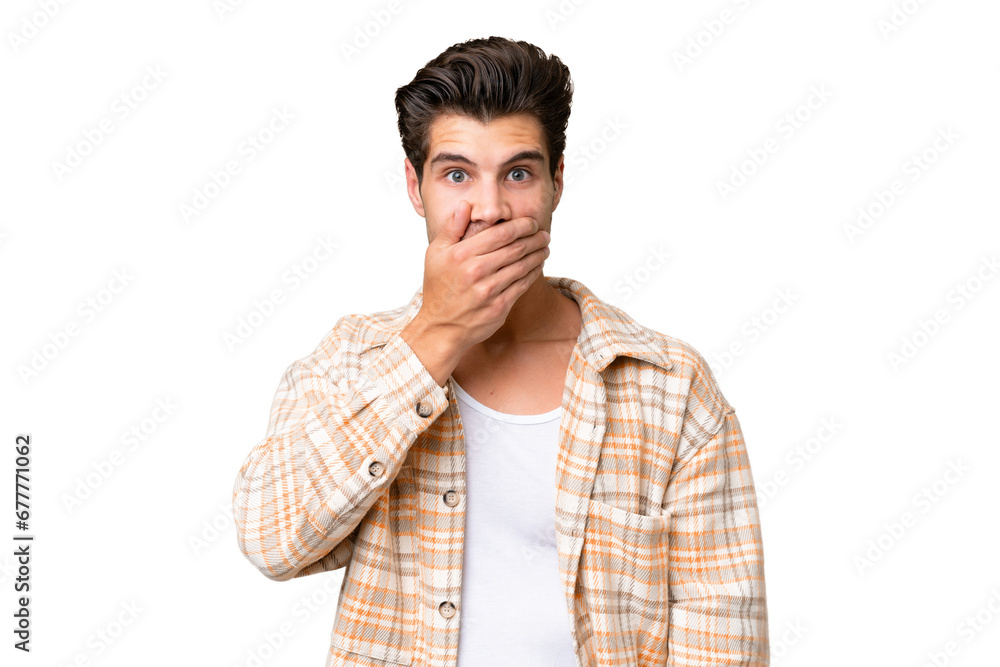 Young handsome caucasian man over isolated background covering mouth with hand Young handsome caucasian man over isolated background covering mouth with hand