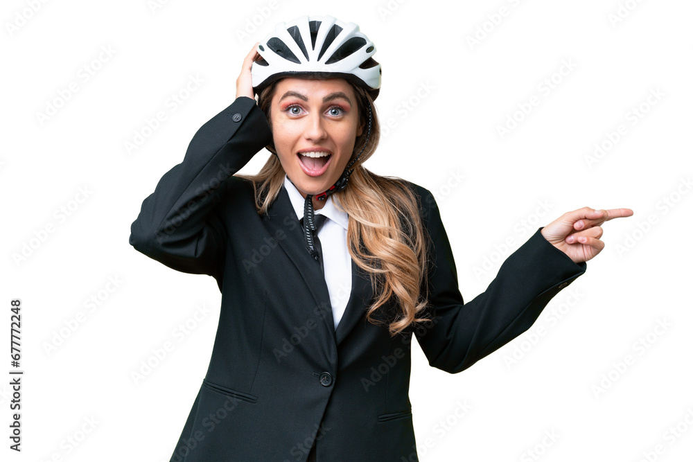 Business Uruguayan woman wearing a helmet biker over isolated background surprised and pointing finger to the side Business Uruguayan woman wearing a helmet biker over isolated background surprised and pointing finger to the side