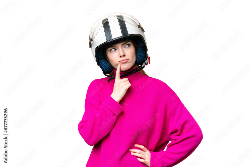 Young pretty woman with a motorcycle helmet over isolated chroma key background having doubts while looking up Young pretty woman with a motorcycle helmet over isolated chroma key background having doubts while looking up