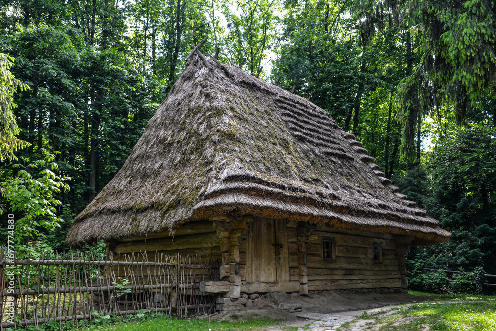 An old wooden house under a thatched roof in Lviv's Skansen neighborhood An old wooden house under a thatched roof in Lviv's Skansen neighborhood