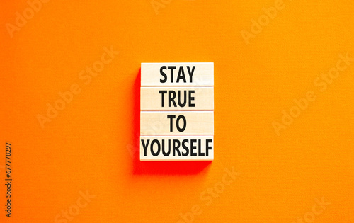 Stay true to yourself symbol. Concept word Stay true to yourself on beautiful wooden block. Beautiful orange table orange background. Business stay true to yourself concept. Copy space