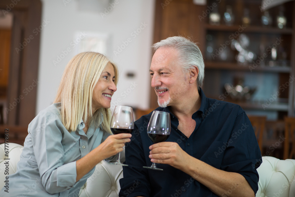 Mature couple enjoying a good glass of red wine