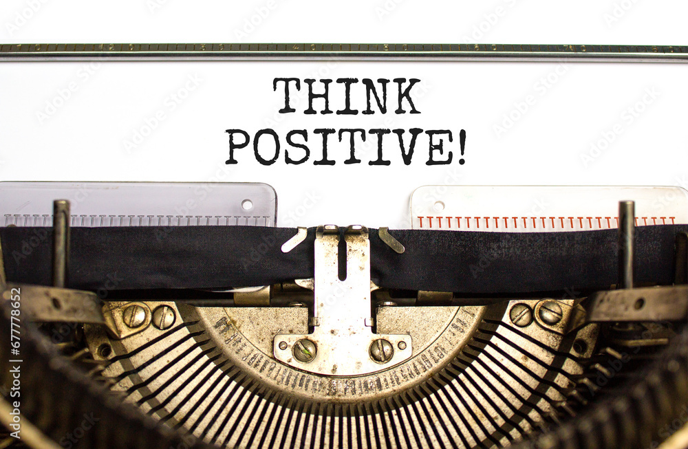 Think positive symbol. Concept words Think positive typed on beautiful old retro typewriter. Beautiful white paper background. Business, motivational think positive thinking concept. Copy space.