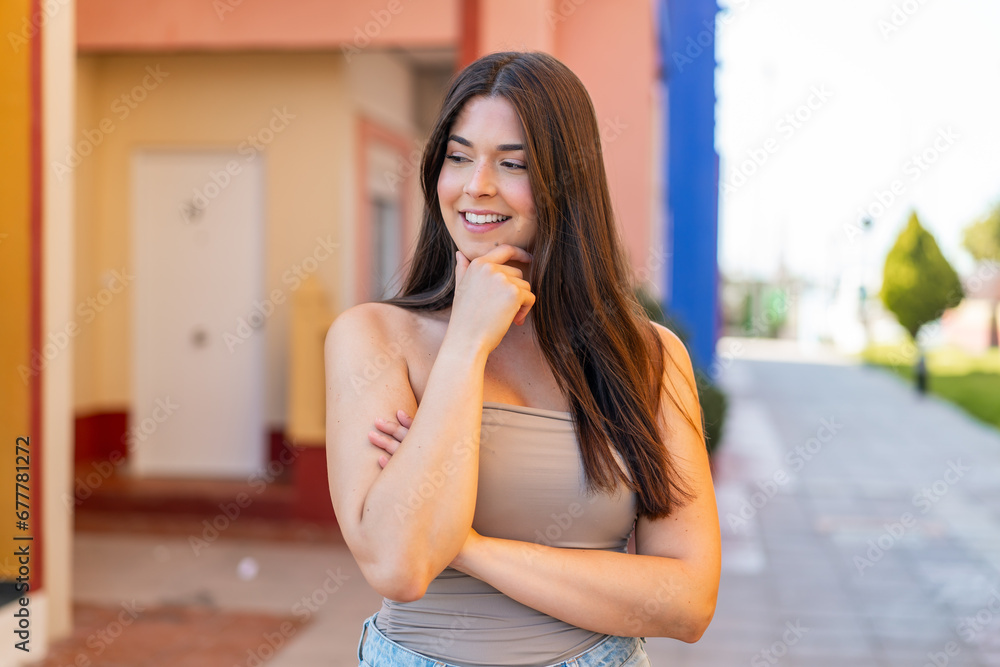 Young pretty Brazilian woman at outdoors looking to the side Young pretty Brazilian woman at outdoors looking to the side