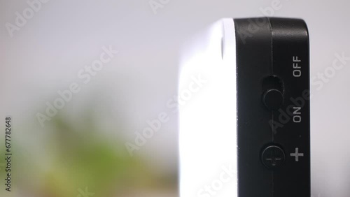 Vlogging light being turned on, macro closeup of finger pushing the button, bright illumination for video, live streaming and zoom meetings