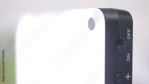Vlogging light being turned on, macro closeup of finger pushing the button, bright illumination for video, live streaming and zoom meetings