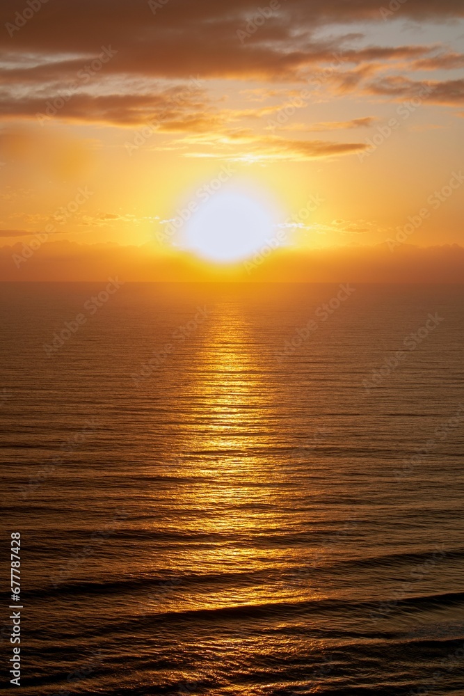 Vertical shot of a tranquil sea at beautiful sunset