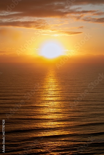 Vertical shot of a tranquil sea at beautiful sunset © Wirestock