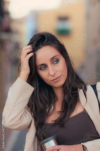 Portrait of a beautiful business woman with blue eyes on the street