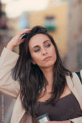 Portrait of a beautiful business woman with blue eyes on the street