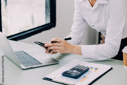 Entrepreneur Asian businessman and businesswoman discussing new business project in tablet in modern Meeting In Modern Office  Asian business casual concept.