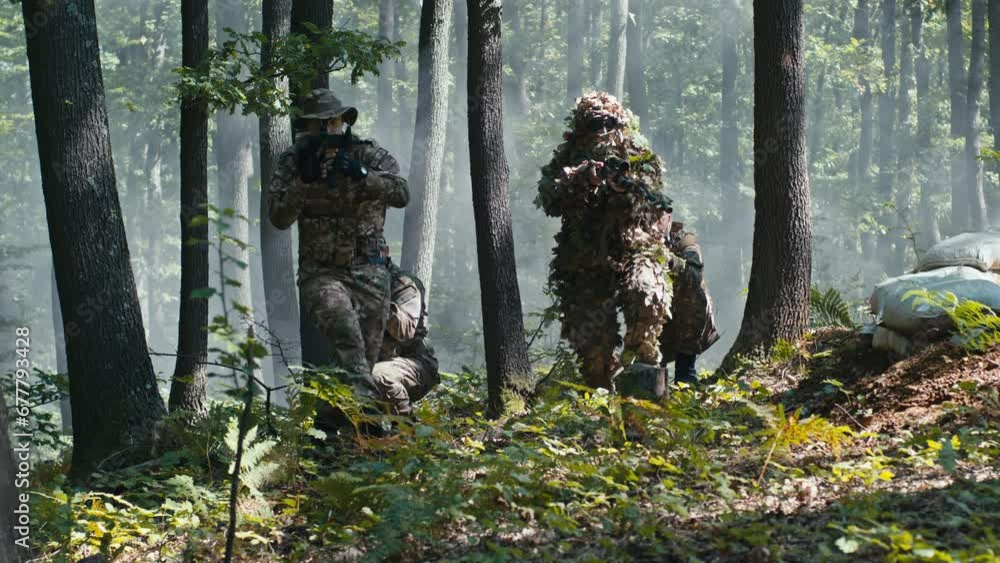 Caucasian Soldiers Moving Forward in the Forest Caucasian Soldiers Moving Forward in the Forest