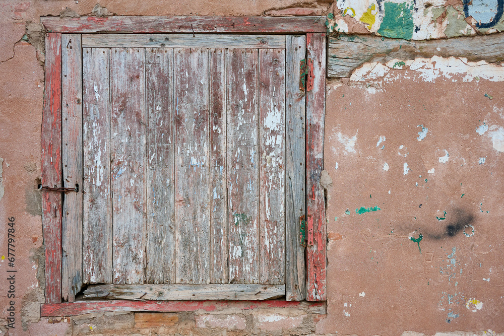 View of the old wooden window over deteriorated wall