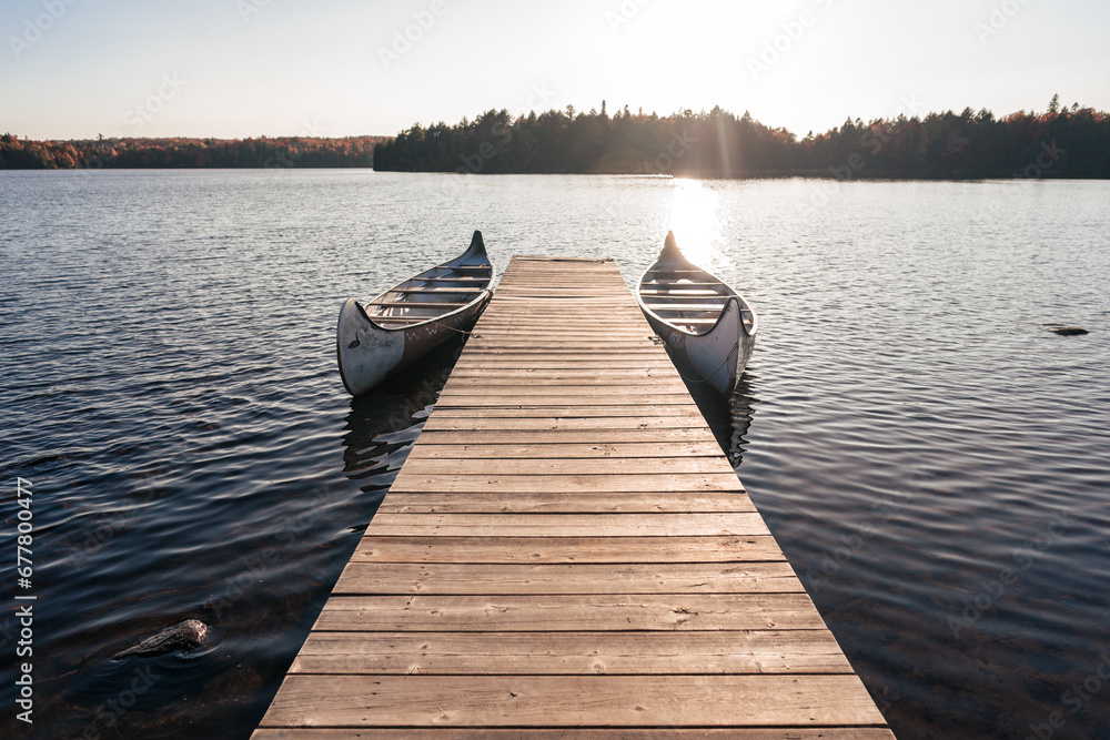 Naklejka premium dock and canoes on the lake