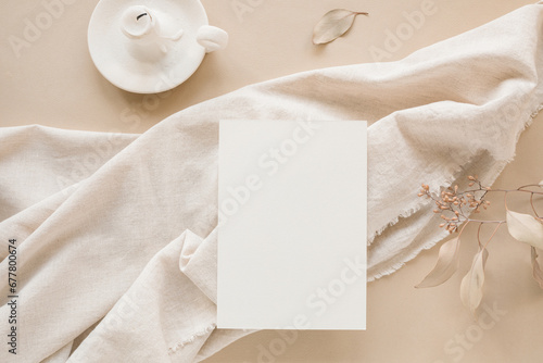 Blank paper mockup on linen fabric. An aesthetic paper card template for a wedding, birthday. The concept of holiday marketing.