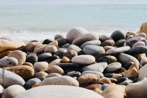 Close-up shot of colorful pebbles on the beach in sunlight