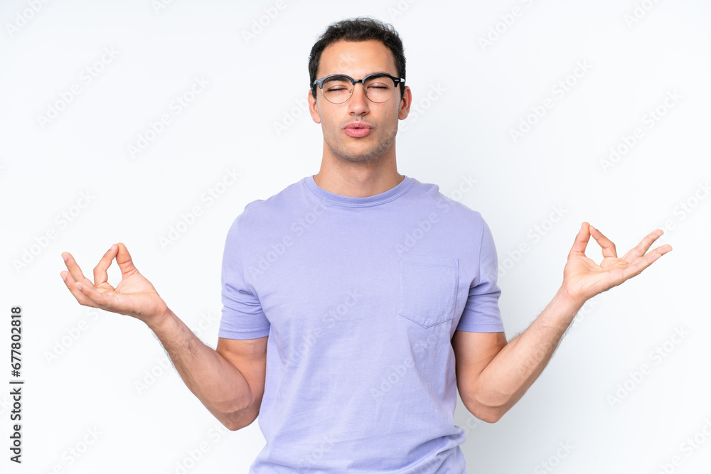 Young caucasian man isolated on white background in zen pose Young caucasian man isolated on white background in zen pose