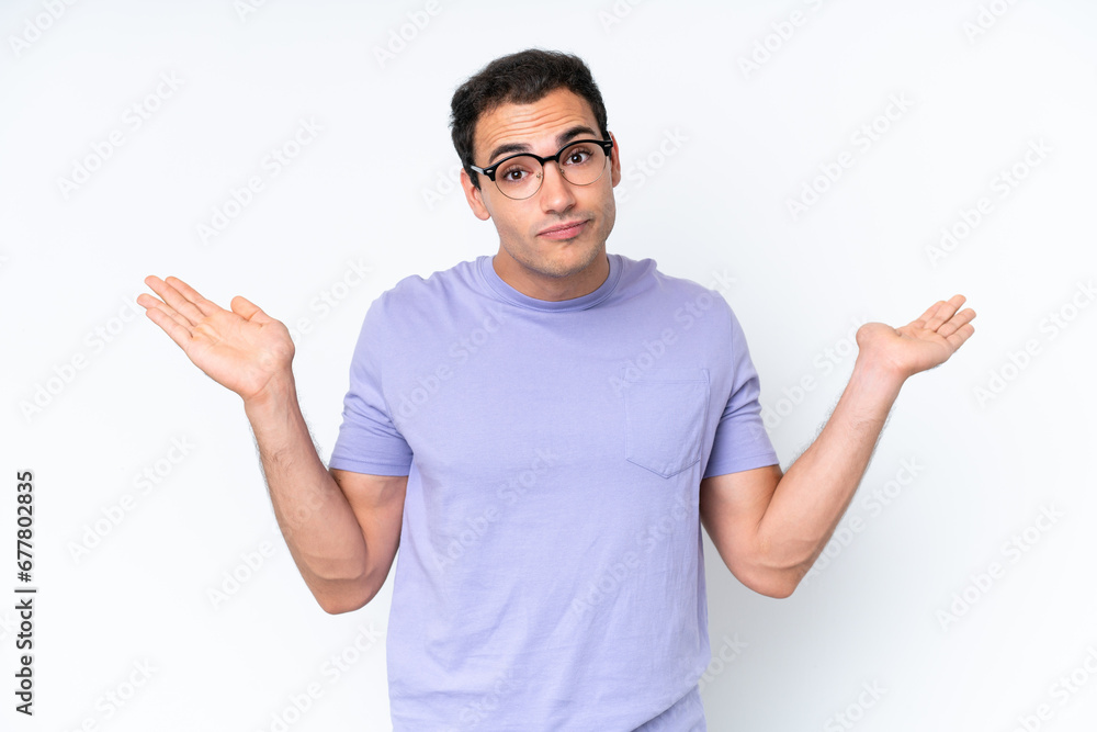Young caucasian man isolated on white background making doubts gesture Young caucasian man isolated on white background making doubts gesture