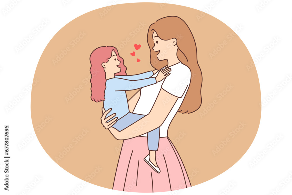 Smiling mother holding small daughter in hands Smiling mother holding small daughter in hands