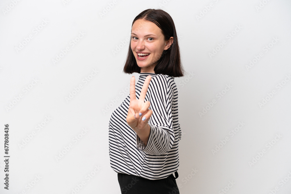 Young caucasian woman isolated on white background smiling and showing victory sign Young caucasian woman isolated on white background smiling and showing victory sign
