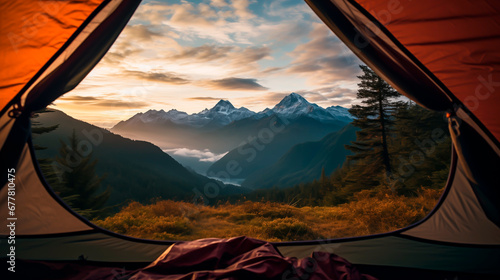 Sunrise view from inside a tent overlooking mountains.