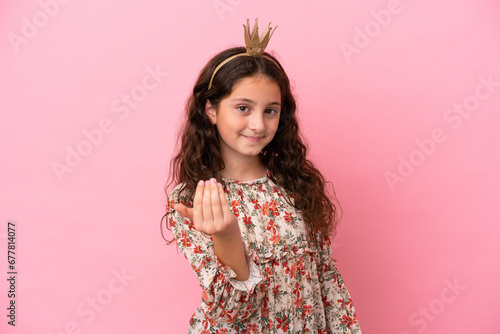 Little caucasian princess with crown isolated on pink background inviting to come with hand. Happy that you came