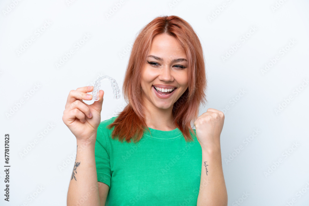Young Russian girl holding invisible braces isolated on white background celebrating a victory Young Russian girl holding invisible braces isolated on white background celebrating a victory