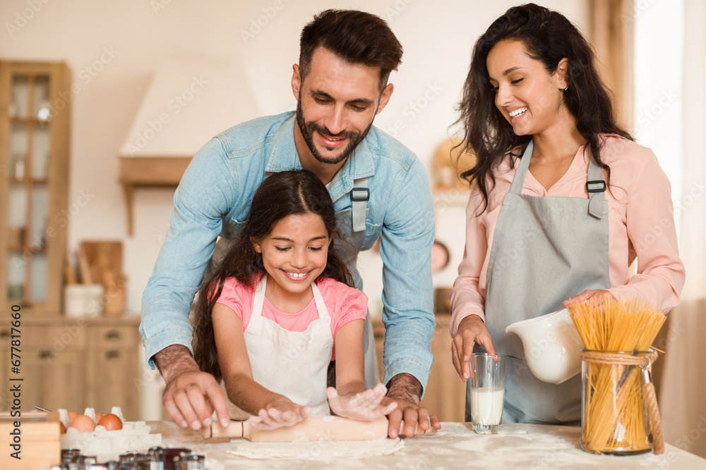 Fototapeta premium Family enjoys baking in sunny kitchen