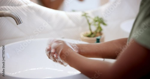 Person, hands and wash soap in sink for clean hygiene in bathroom bacteria, disinfection or protection. Fingers, foam liquid and bubbles for wellness or water safety as virus infection, care or germs photo