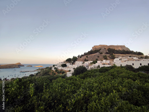 Village of Lindos with the ancient acropolis on the hilltop and the bay with the islets below. Dodecanese, Rhodes island, Greece.