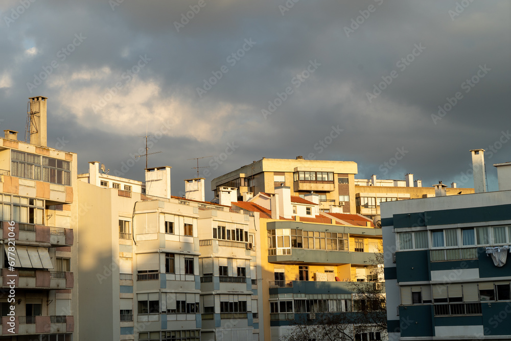 Buildings under a cloudy dark sky