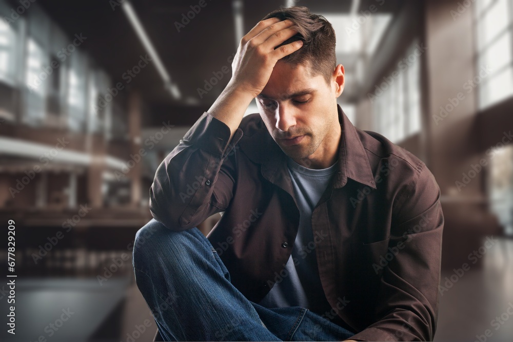 Sad depressed person sitting on sofa at home Sad depressed person sitting on sofa at home