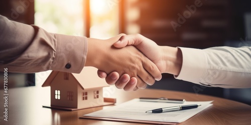Real estate agent shaking hands with client after signing contract © muji