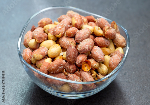 Salted peanuts in a glass bowl