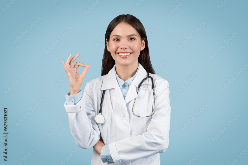Happy young female doctor showing OK sign with hand Happy young female doctor showing OK sign with hand