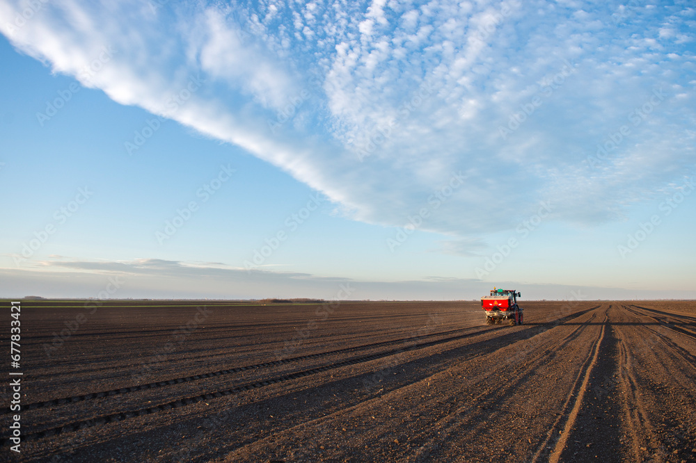 Tractor spreading artificial fertilizers Tractor spreading artificial fertilizers