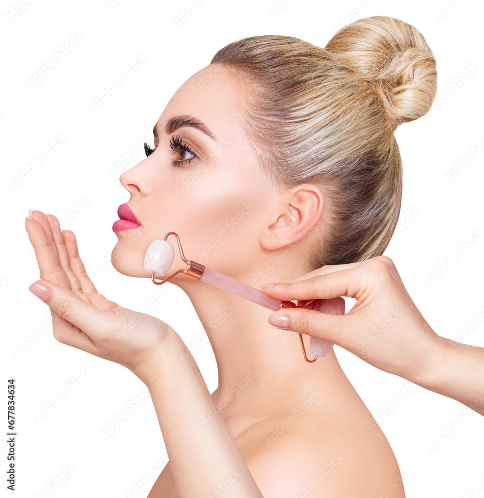 Young woman using pink quartz gua sha roller for face. Young woman using pink quartz gua sha roller for face.