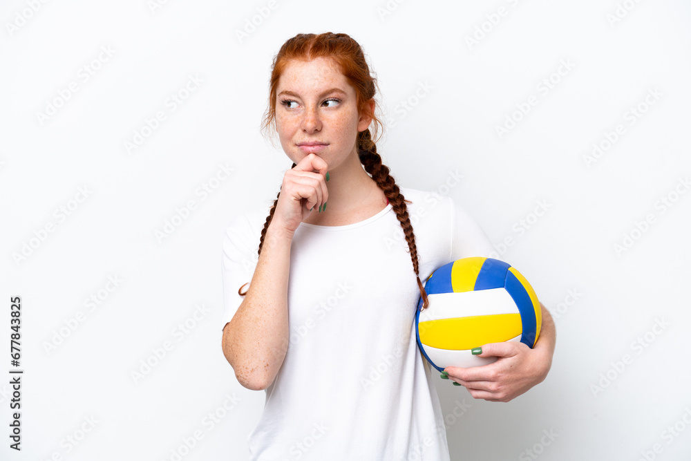 Young caucasian reddish woman playing volleyball isolated on white background and looking up Young caucasian reddish woman playing volleyball isolated on white background and looking up