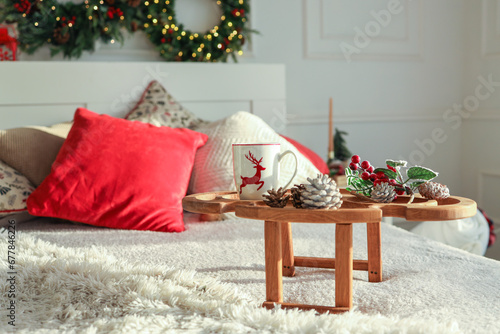 Wooden tray with breakfast on the bed